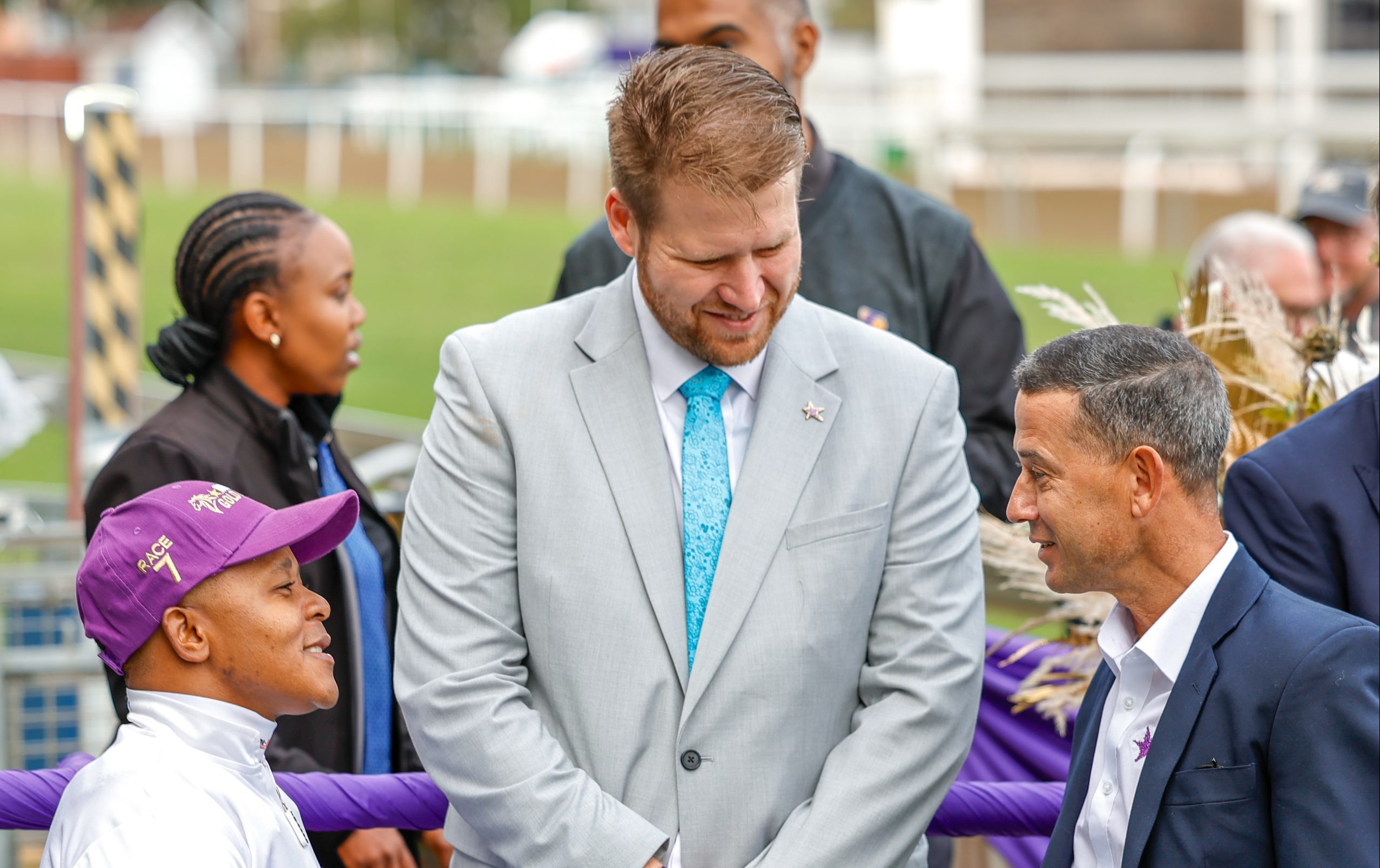 Hollywoodbets’ Devin Heffer is flanked by winning rider Muzi Yeni and Anthony Delpech