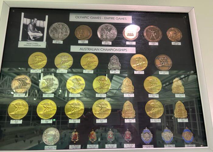 Frank O’Neill’s medals are on display at the Andrew “Boy” Charlton Aquatic Centre, Manly (Pic - Courtesy Manly Swimming Club)