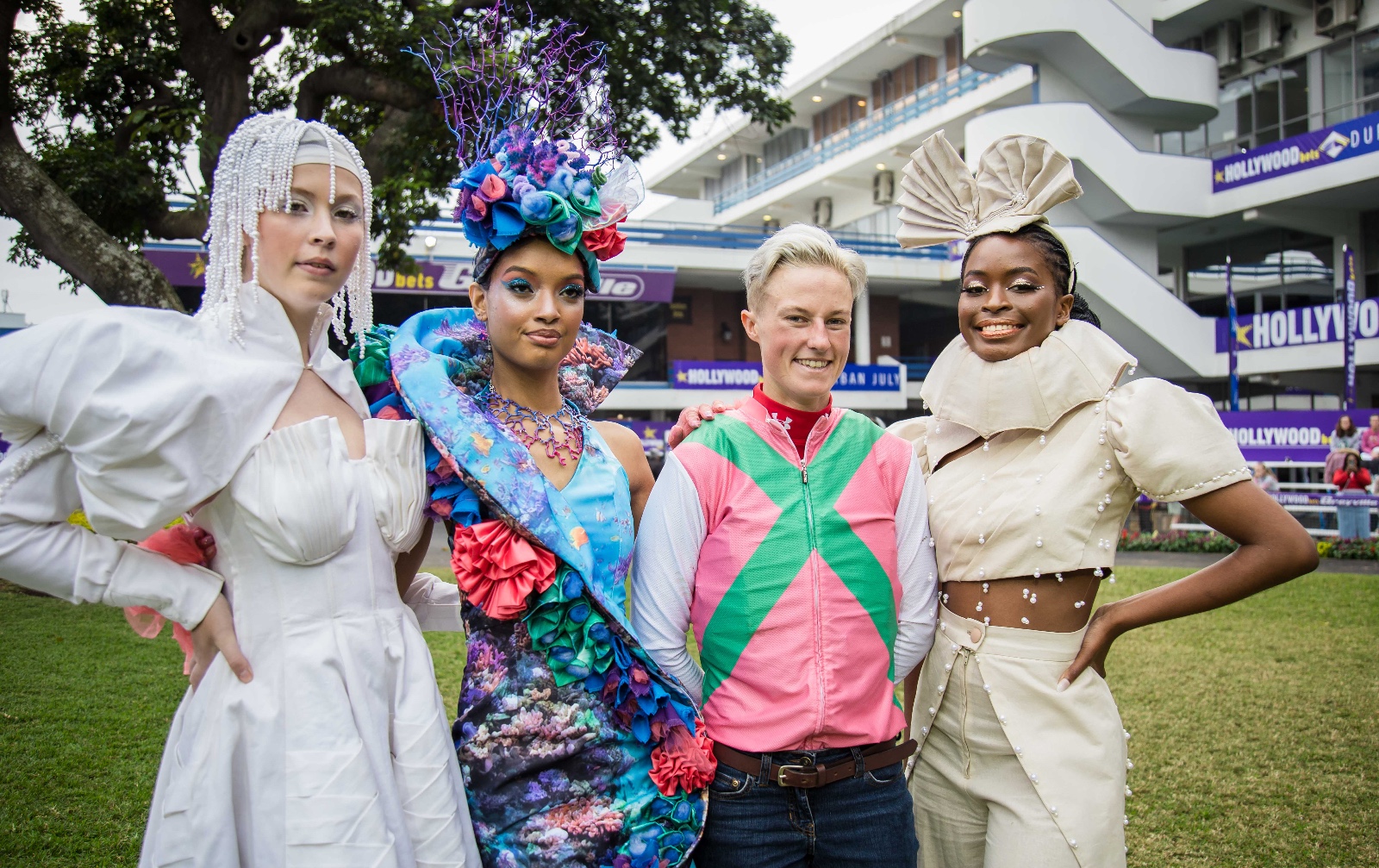Young Designer top 10 finalist models (from left) Abigail Paterson (designer Nontsikelelo Godlo), Cheri-Lee Thangalan (designer Krishan Ramdewu) and (far right) Sibu Ngema (designer Ndlozi Sineziwe) with the Hollywoodbets Durban July's first female jockey, Rachel Venniker, in the parade ring after the official Gallops held at Hollywoodbets Greyville Racecourse last week. Graham Daniel Gameplan Media