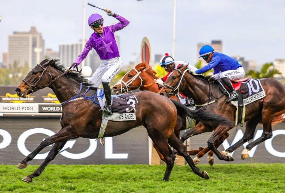 A delighted Calvin Habib salutes as VJ’s Angel storms home to beat The Specialist (Smanga Khumalo) and Grand Crescendo (Muzi Yeni) in a superb finish (Pic – Candiese Lenferna)