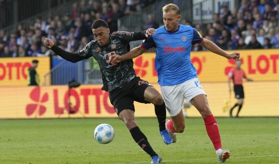 Jamal Musiala (L) in action against Timo Becker (R) during the German Bundesliga soccer match between Holstein Kiel and FC Bayern Munich (Pic - EPA/Martin Ziemer)