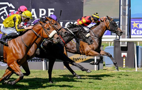 Rascallion (Gavin Lerena) delivers a stakes success taking on Zapatillas (Kabelo Matsunyane, purple cap), Gimme A Prince (Craig Zackey, yellow cap) and Montien (Anthony Andrews, pink cap) in a nail-biting fight to the line (Pic – Chase Liebenberg)