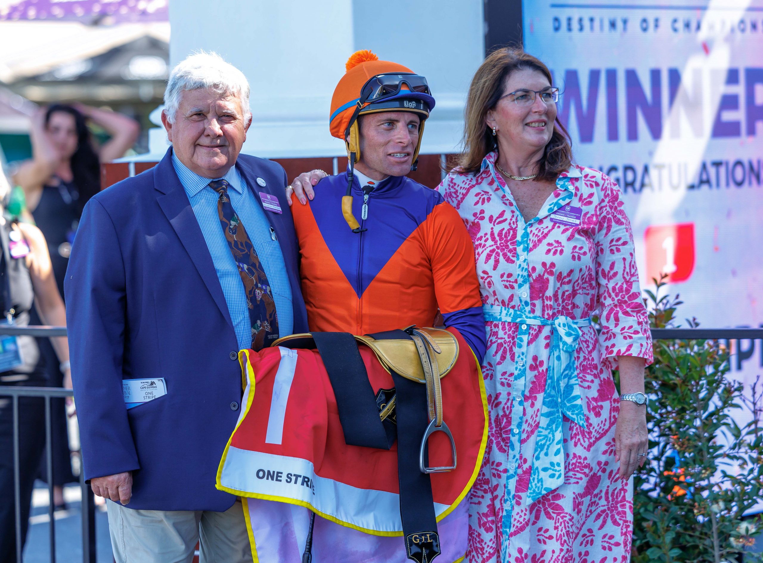 Gavin Lerena is flanked by trainer Vaughan Marshall and his partner Jenny Jones after One Stripe’s cracking win