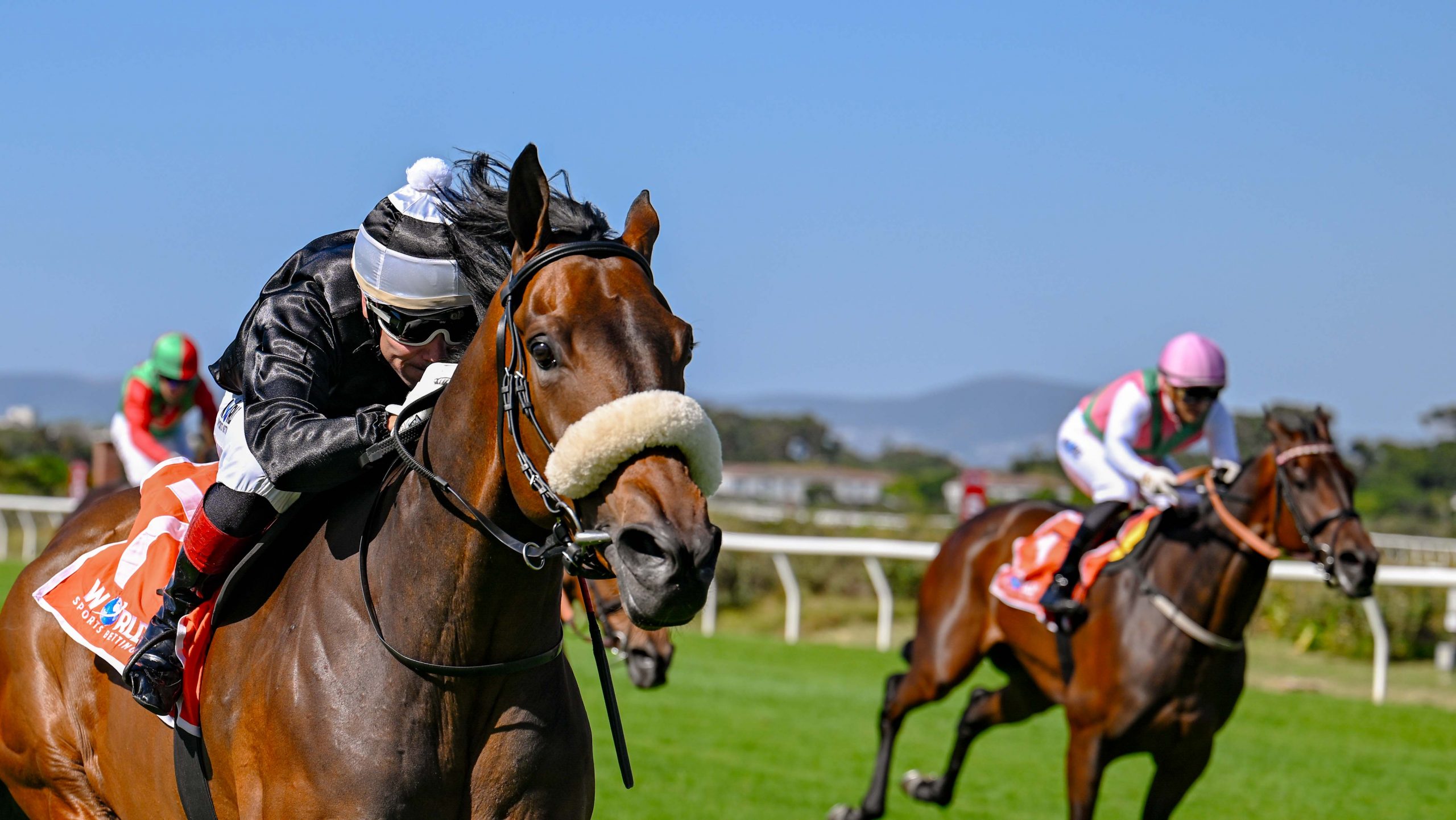 Hold Thumbs (Sean Veale) stay on the winning path! Call To Unite (Grant van Niekerk, pink cap) and Royal Invitation (Anthony Andrews) can be seen in the background (Pic - Chase Liebenberg)