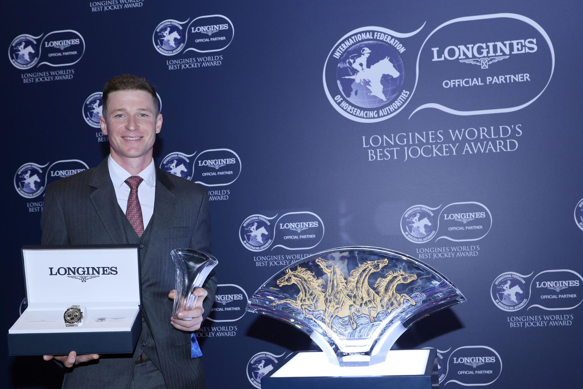 James McDonald is presented with a LONGINES watch and crystal vase (Pic - HKJC)